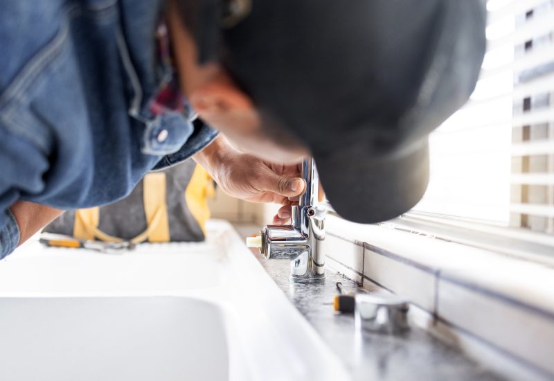 plumber-fixing-faucet